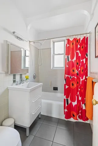 a bathroom with a sink toilet vanity and tub