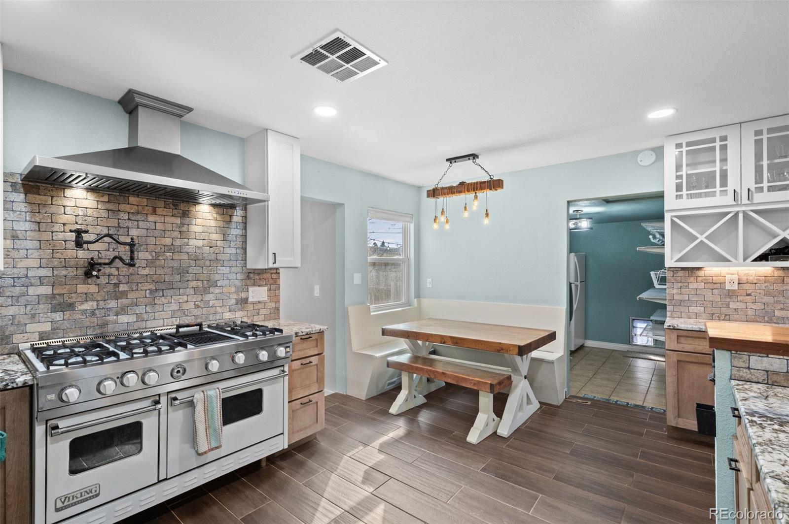 776 South Yates Street Denver, CO 80219 - Photo 13 of 34 a kitchen with a stove and a wooden floor