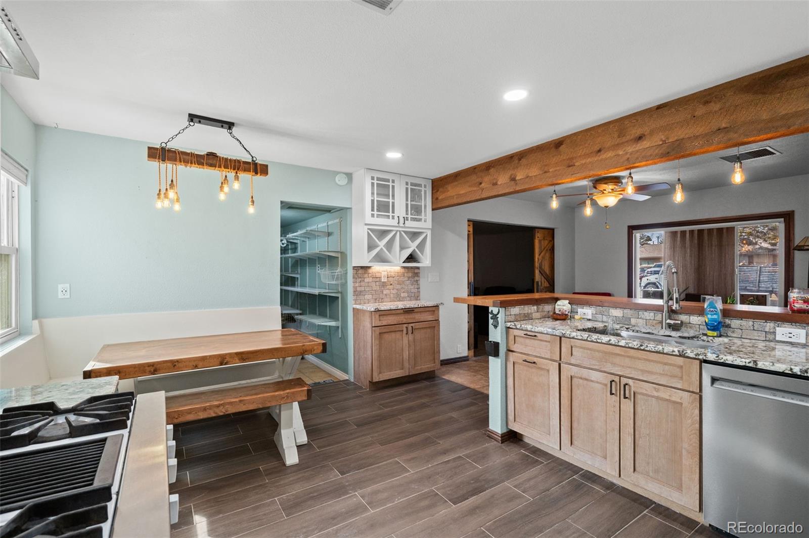 776 South Yates Street Denver, CO 80219 - Photo 14 of 34 a kitchen with a stove and a refrigerator