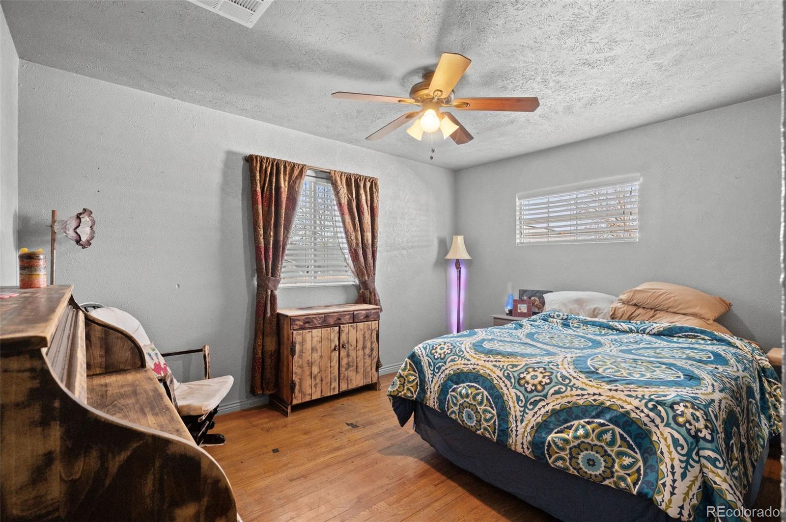 776 South Yates Street Denver, CO 80219 - Photo 18 of 34 a bedroom with a bed and a chandelier