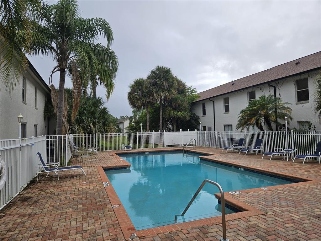 3651 North Goldenrod Road, Unit B#104 Winter Park, FL 32792 - Photo 2 of 21 a swimming pool with outdoor seating and yard