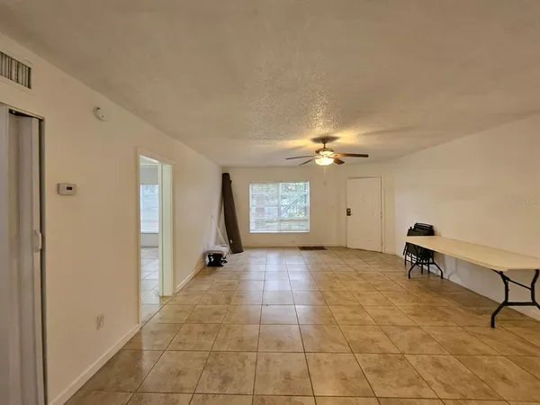 a view of a livingroom with a ceiling fan and window