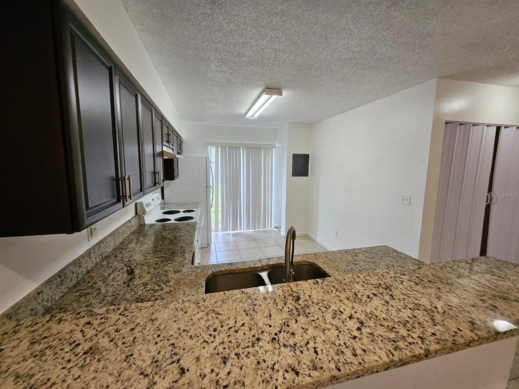 3651 North Goldenrod Road, Unit B#104 Winter Park, FL 32792 - Photo 4 of 21 a bathroom with a granite countertop sink and a large mirror