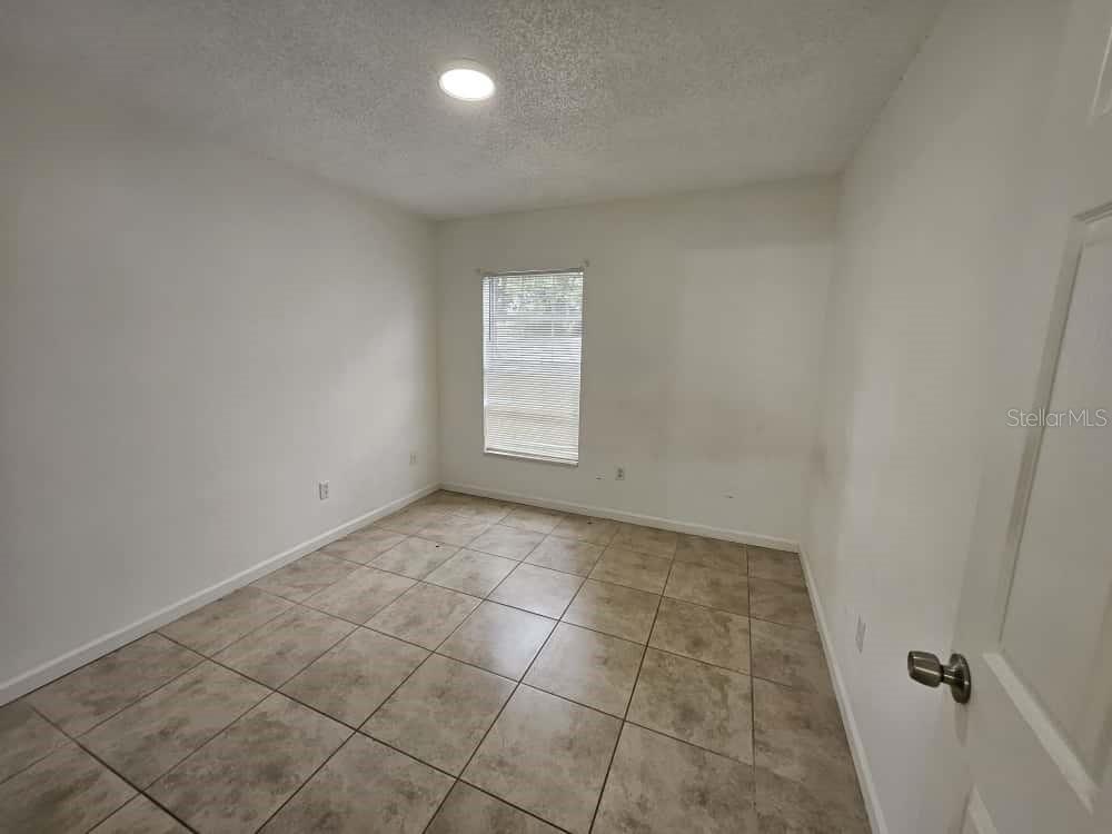 3651 North Goldenrod Road, Unit B#104 Winter Park, FL 32792 - Photo 9 of 21 an empty room with a empty space and windows