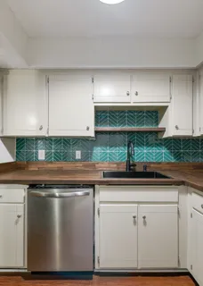 a kitchen with a refrigerator and a stove