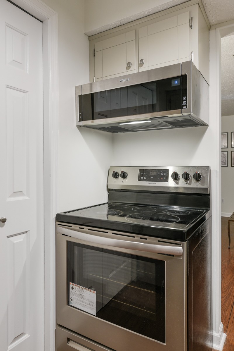 1808 State Street, Unit 307 Nashville, TN 37203 - Photo 13 of 27 a stove top oven sitting inside of a kitchen