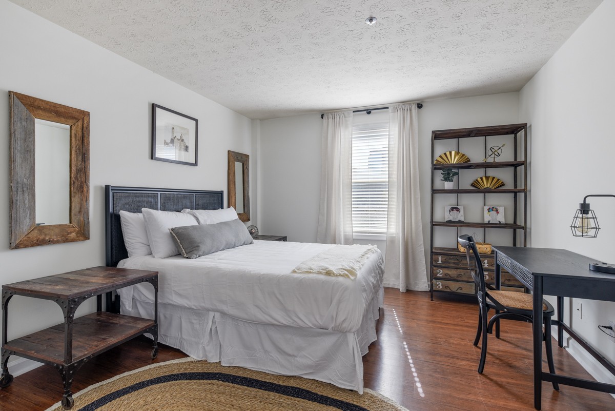 1808 State Street, Unit 307 Nashville, TN 37203 - Photo 16 of 27 a bedroom with a bed a table and chair