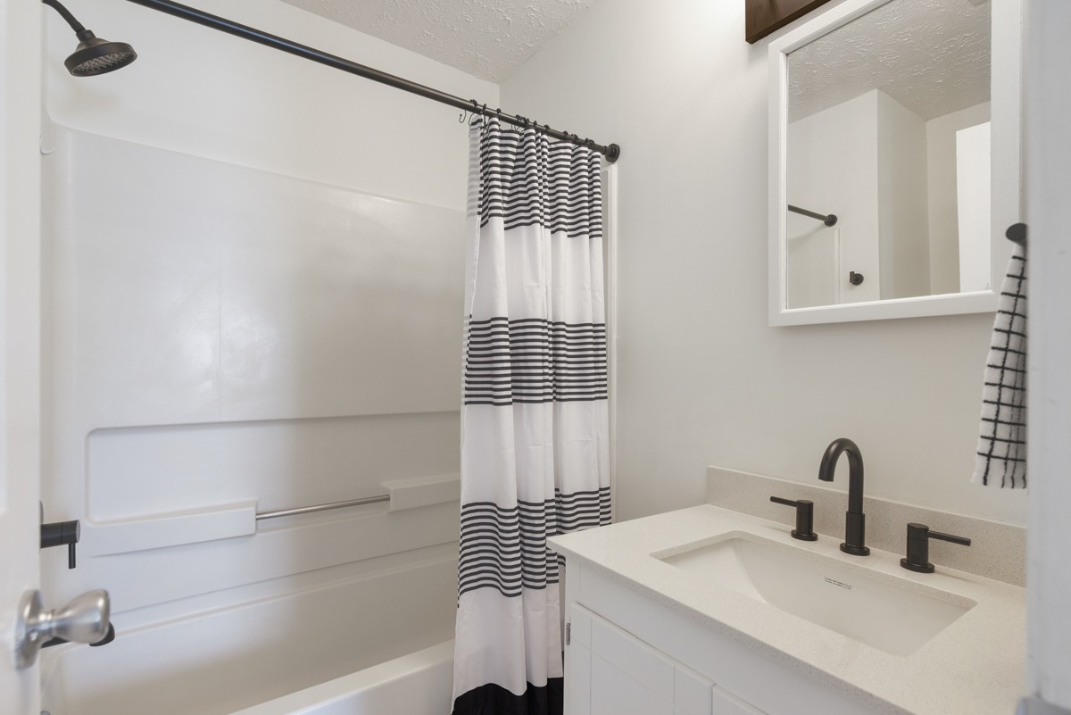 1808 State Street, Unit 307 Nashville, TN 37203 - Photo 20 of 27 a bathroom with a sink and a mirror
