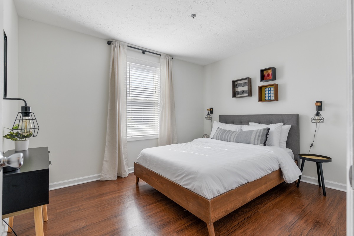 1808 State Street, Unit 307 Nashville, TN 37203 - Photo 23 of 27 a bedroom with a bed and wooden floor