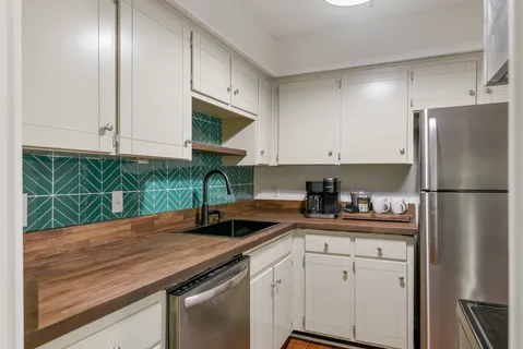 a kitchen with a sink a counter top space and cabinets