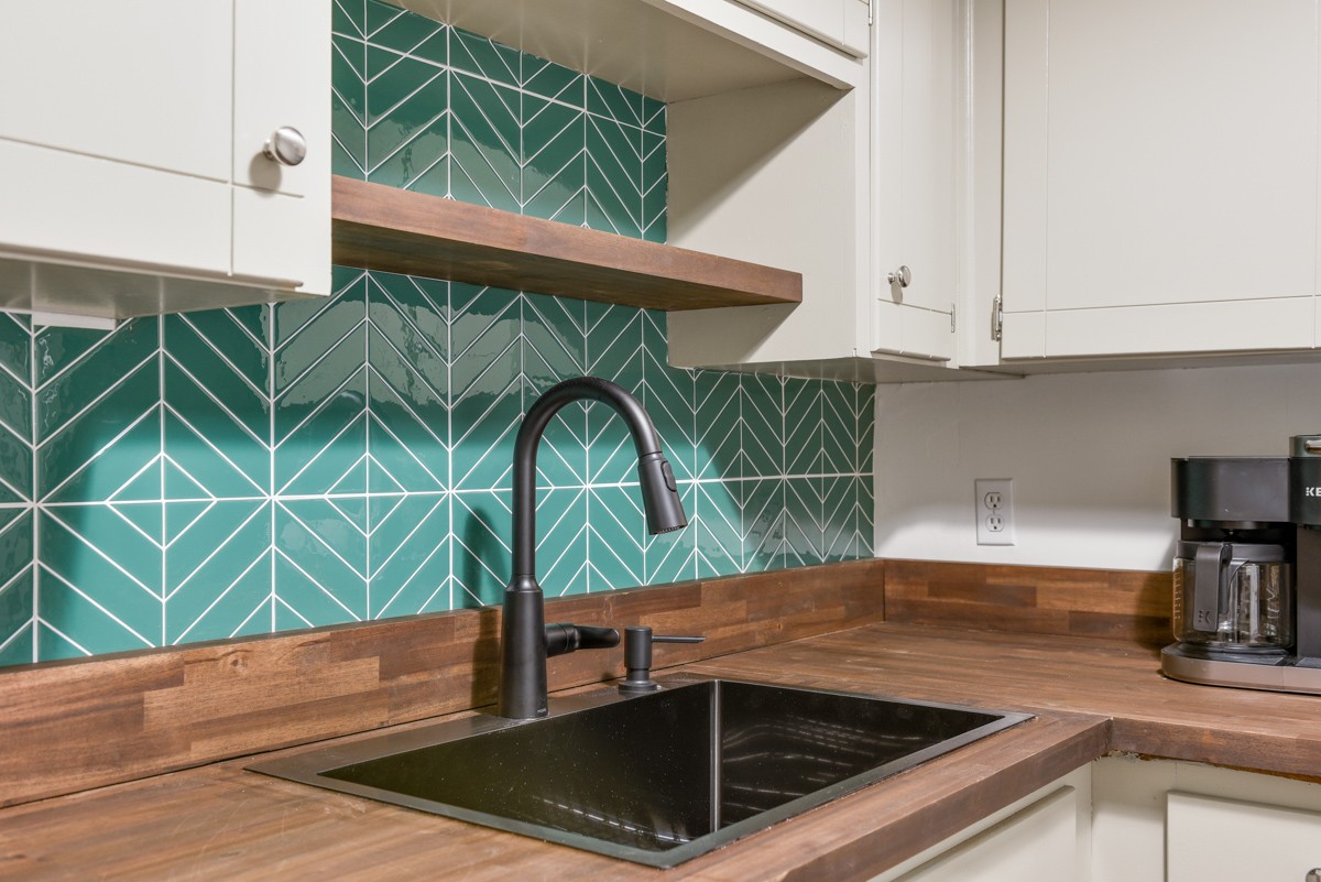 1808 State Street, Unit 307 Nashville, TN 37203 - Photo 10 of 27 a kitchen with a sink a counter top space and cabinets