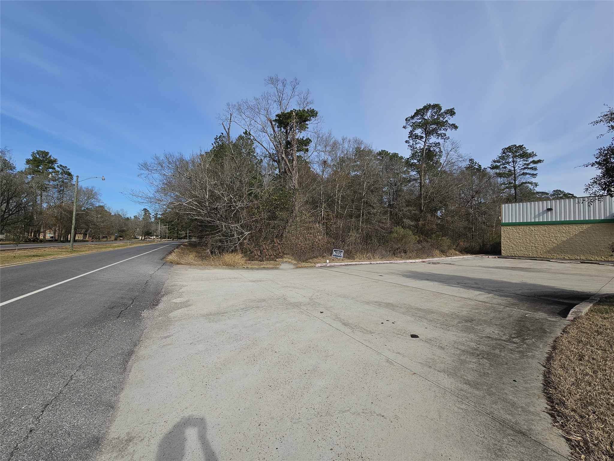 0 Roman Forest Boulevard New Caney, TX 77357 - Photo 11 of 11 a view of a road with a building in the background