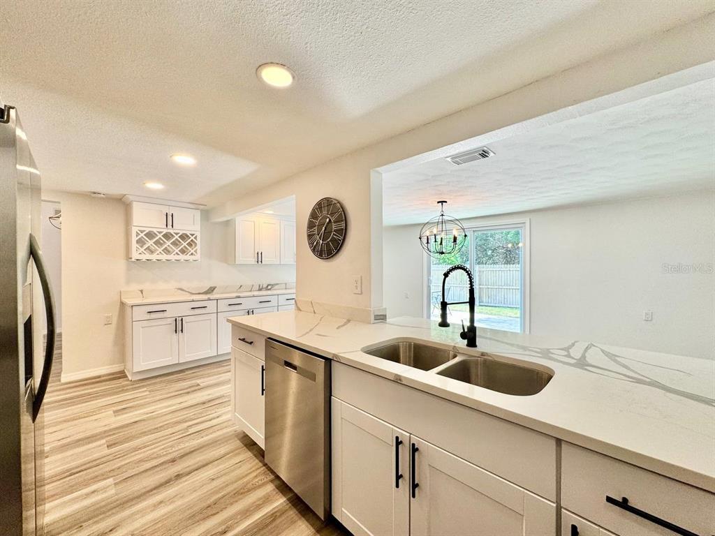 4282 Rudder Way New Port Richey, FL 34652 - Photo 22 of 34 a kitchen with a sink and a refrigerator