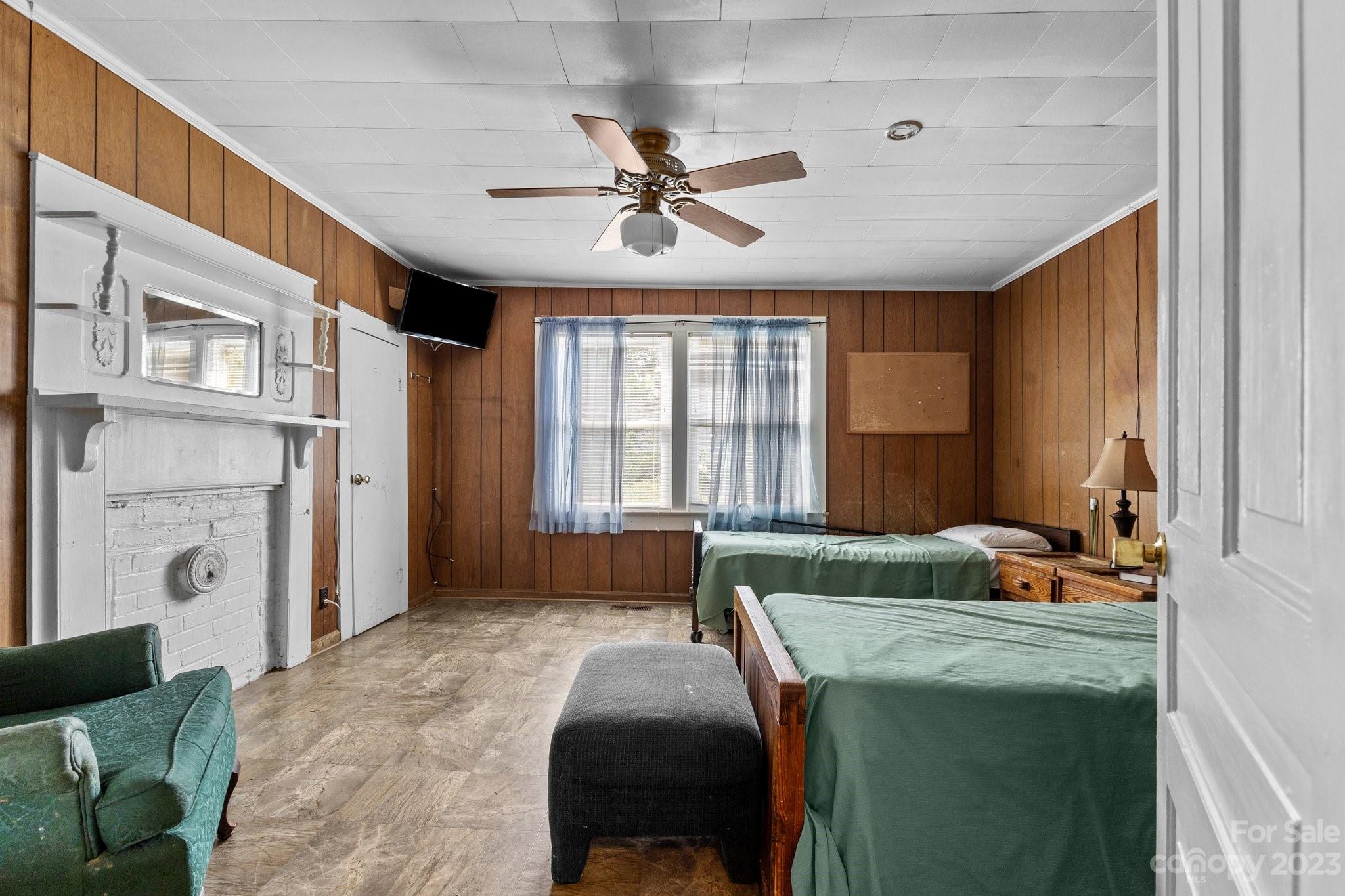 602 Aileen Avenue Biscoe, NC 27209 - Photo 11 of 27 a bedroom with a bed and a chandelier