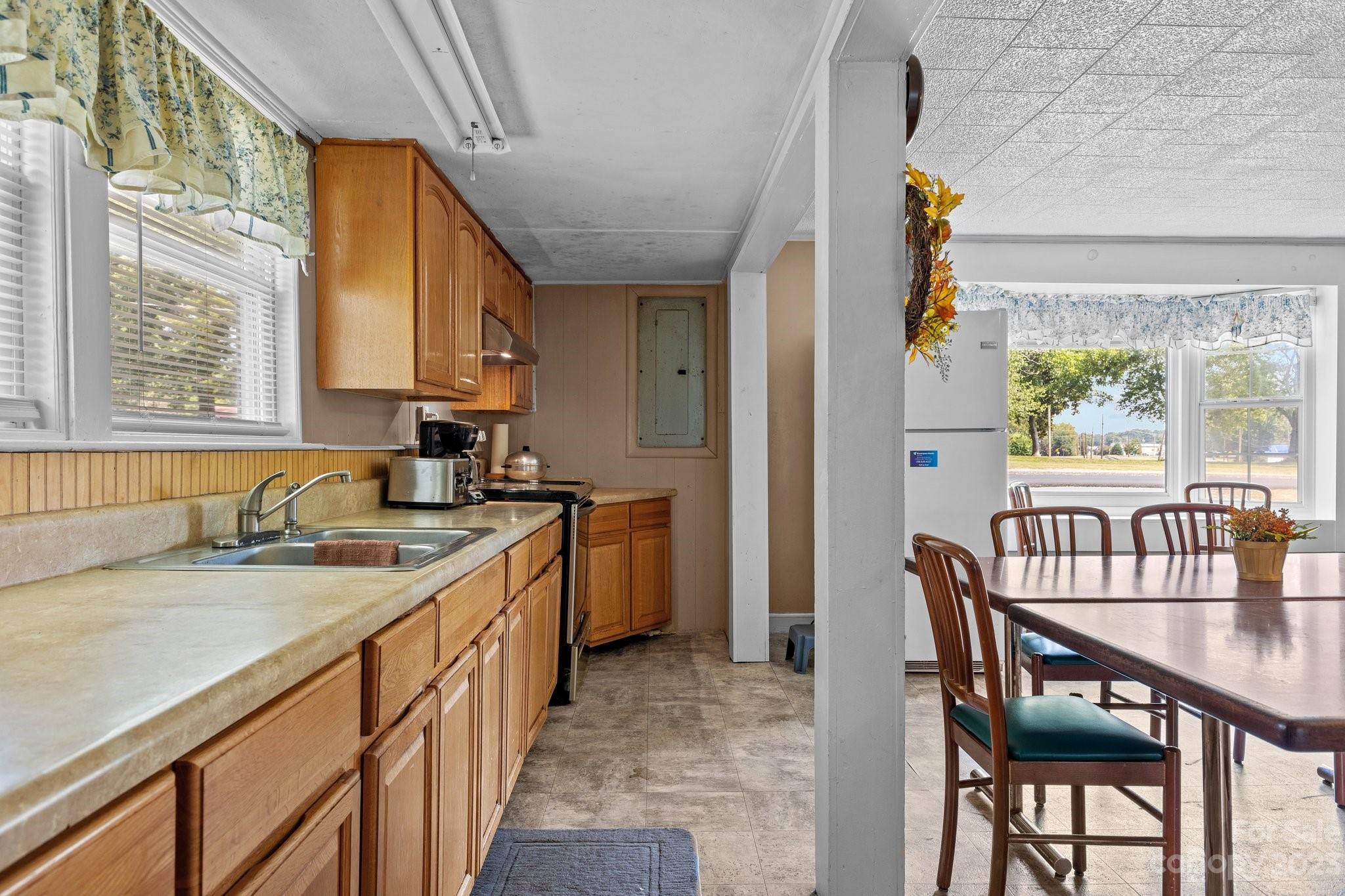 602 Aileen Avenue Biscoe, NC 27209 - Photo 20 of 27 a kitchen with a table chairs sink and cabinets