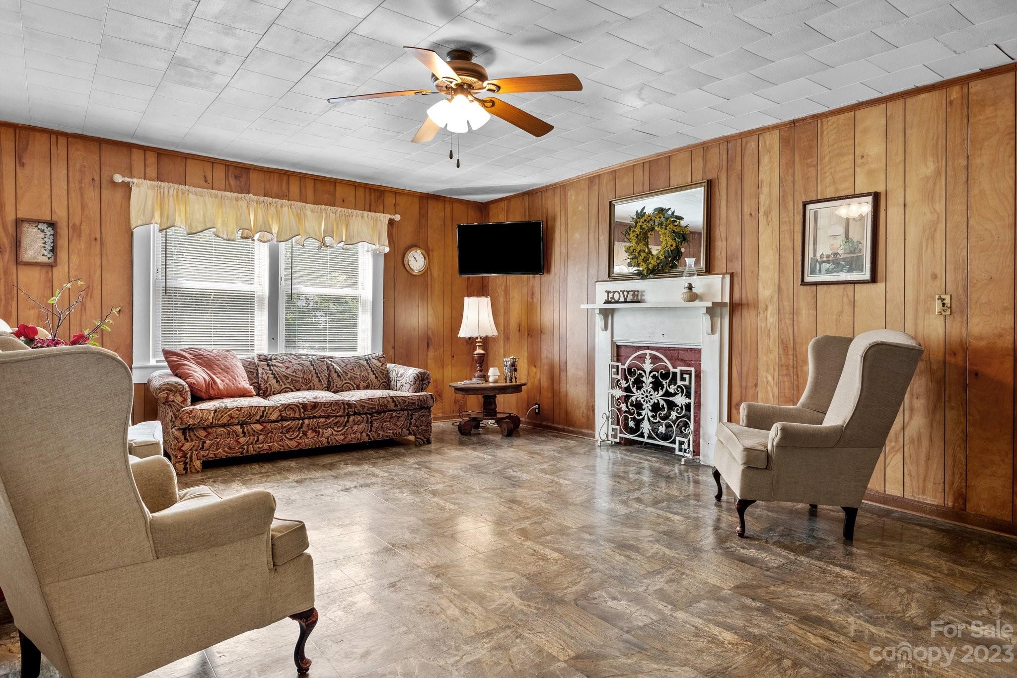 602 Aileen Avenue Biscoe, NC 27209 - Photo 3 of 27 a living room with furniture a fireplace and a large window