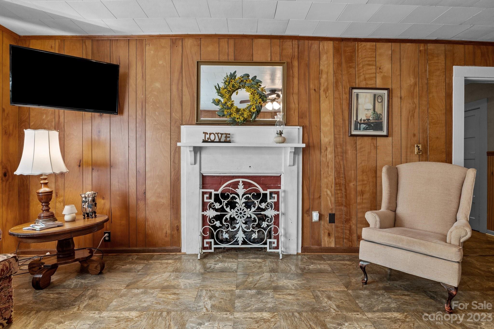602 Aileen Avenue Biscoe, NC 27209 - Photo 4 of 27 a living room with furniture a flat screen tv and a fireplace