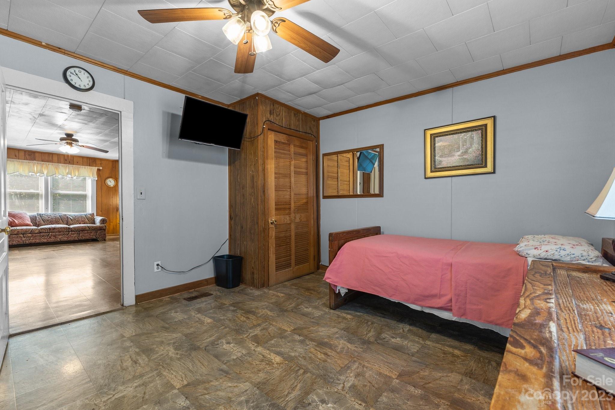 602 Aileen Avenue Biscoe, NC 27209 - Photo 7 of 27 a bedroom with a bed and a chandelier