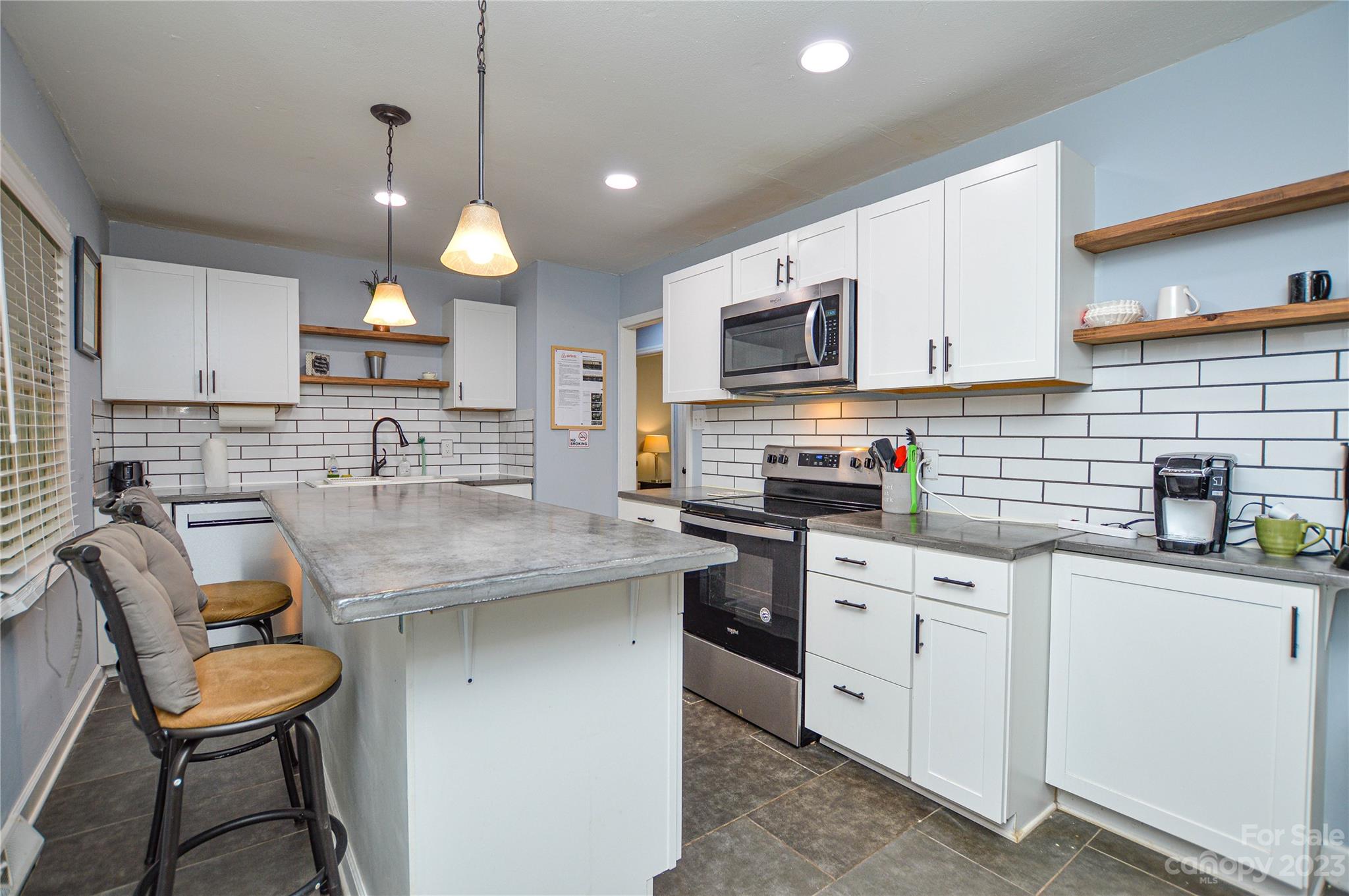 931 Tilden Road Charlotte, NC 28214 - Photo 14 of 33 a kitchen with cabinets appliances and a counter top space
