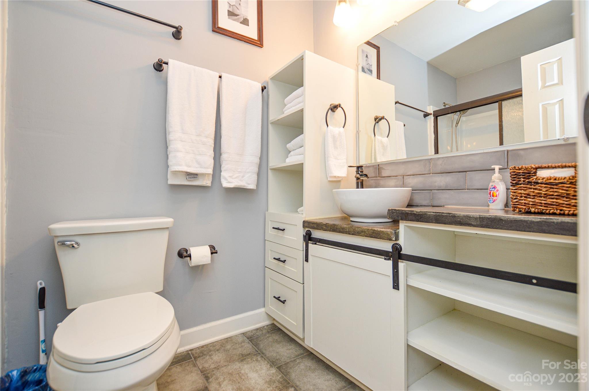 931 Tilden Road Charlotte, NC 28214 - Photo 24 of 33 a bathroom with a toilet a sink and a window