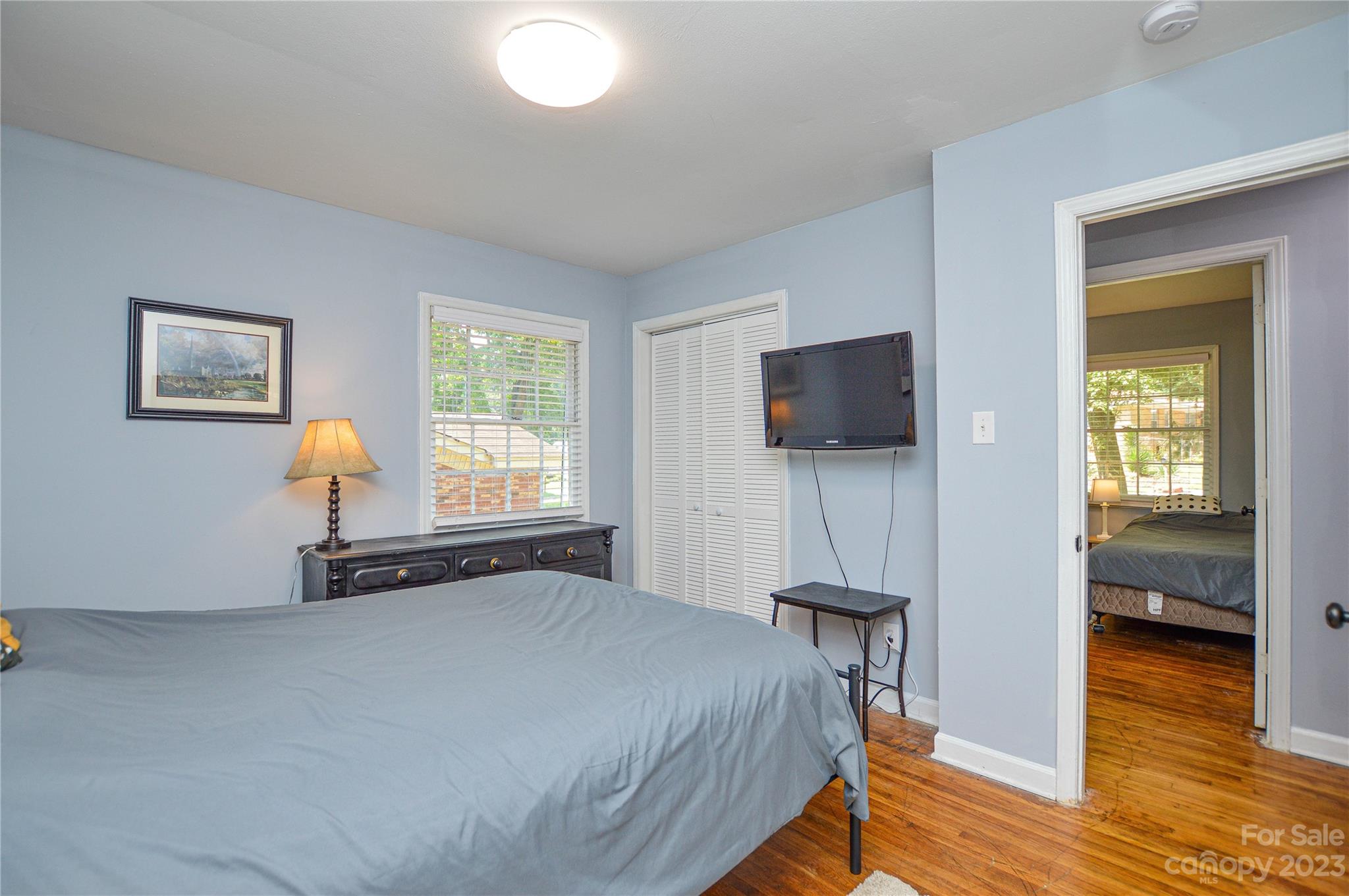 931 Tilden Road Charlotte, NC 28214 - Photo 27 of 33 a bedroom with a bed and flat tv screen on a dresser
