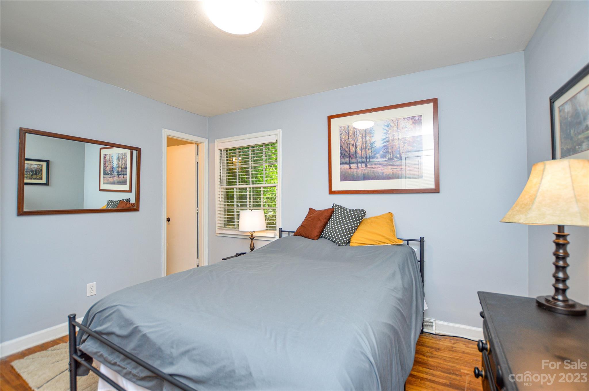 931 Tilden Road Charlotte, NC 28214 - Photo 28 of 33 a bedroom with a bed and wooden floor