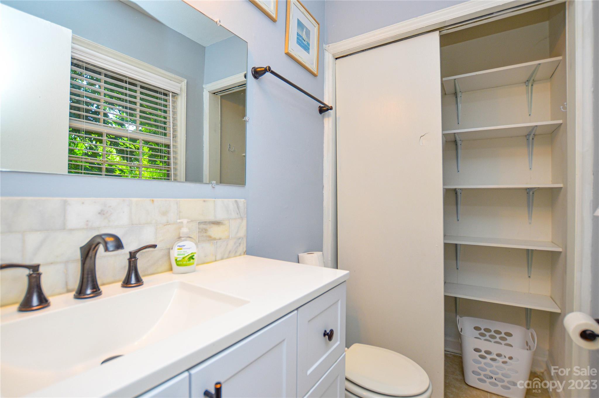 931 Tilden Road Charlotte, NC 28214 - Photo 29 of 33 a bathroom with a sink and a toilet