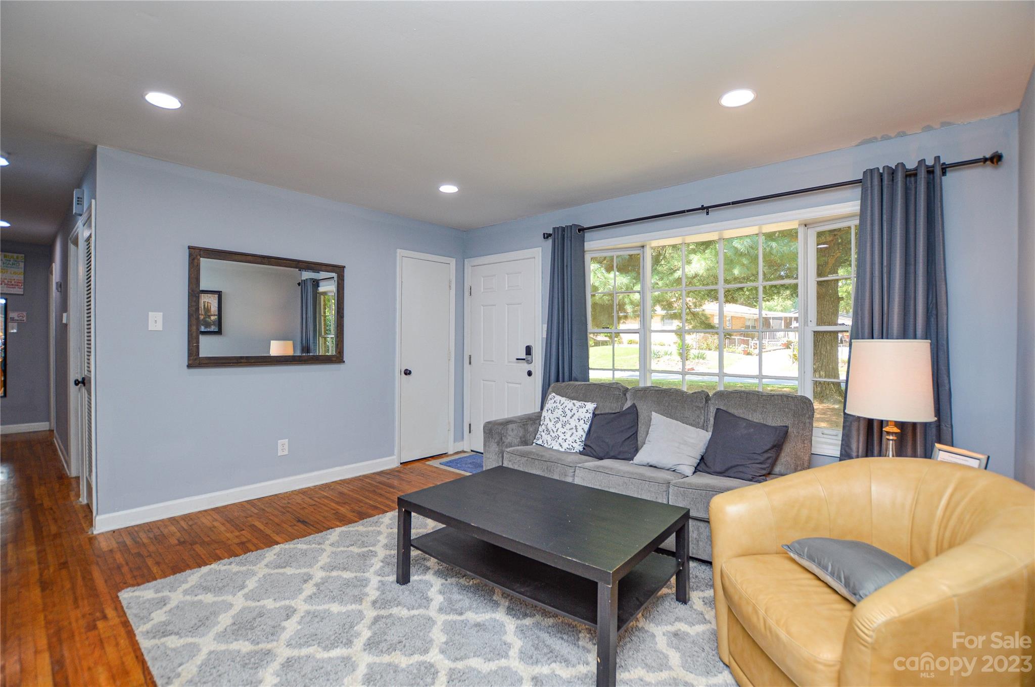 931 Tilden Road Charlotte, NC 28214 - Photo 7 of 33 a living room with furniture and a large window