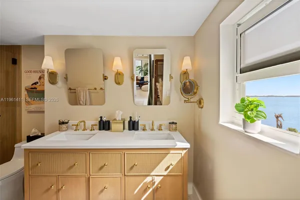 a bathroom with a granite countertop sink a mirror and vanity