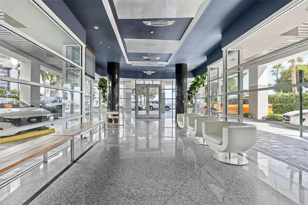 a dining hall with stainless steel appliances granite countertop a large window