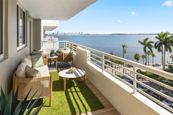 a view of balcony with furniture and wooden floor