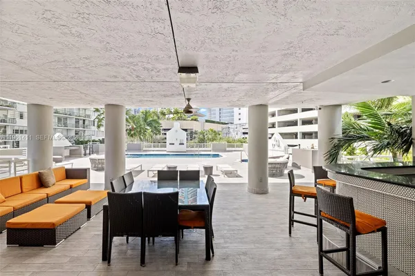a view of kitchen with stainless steel appliances a stove and a wooden floor