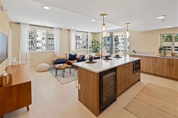 a kitchen with a sink counter top space and living room