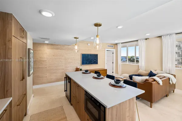 a kitchen with sink refrigerator and large window