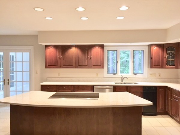 42 Phillips Road Sudbury, MA 01776 - Photo 8 of 28 a kitchen with a sink a stove and cabinets