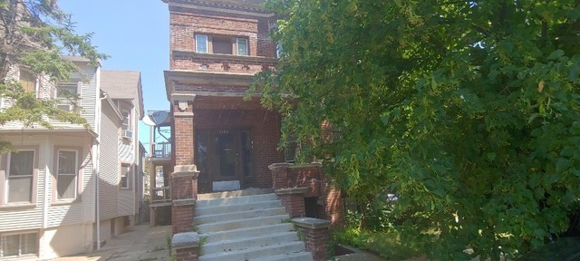 3534 West Wrightwood Avenue Chicago, IL 60647 - Photo 2 of 15 a view of a brick buildings with many windows