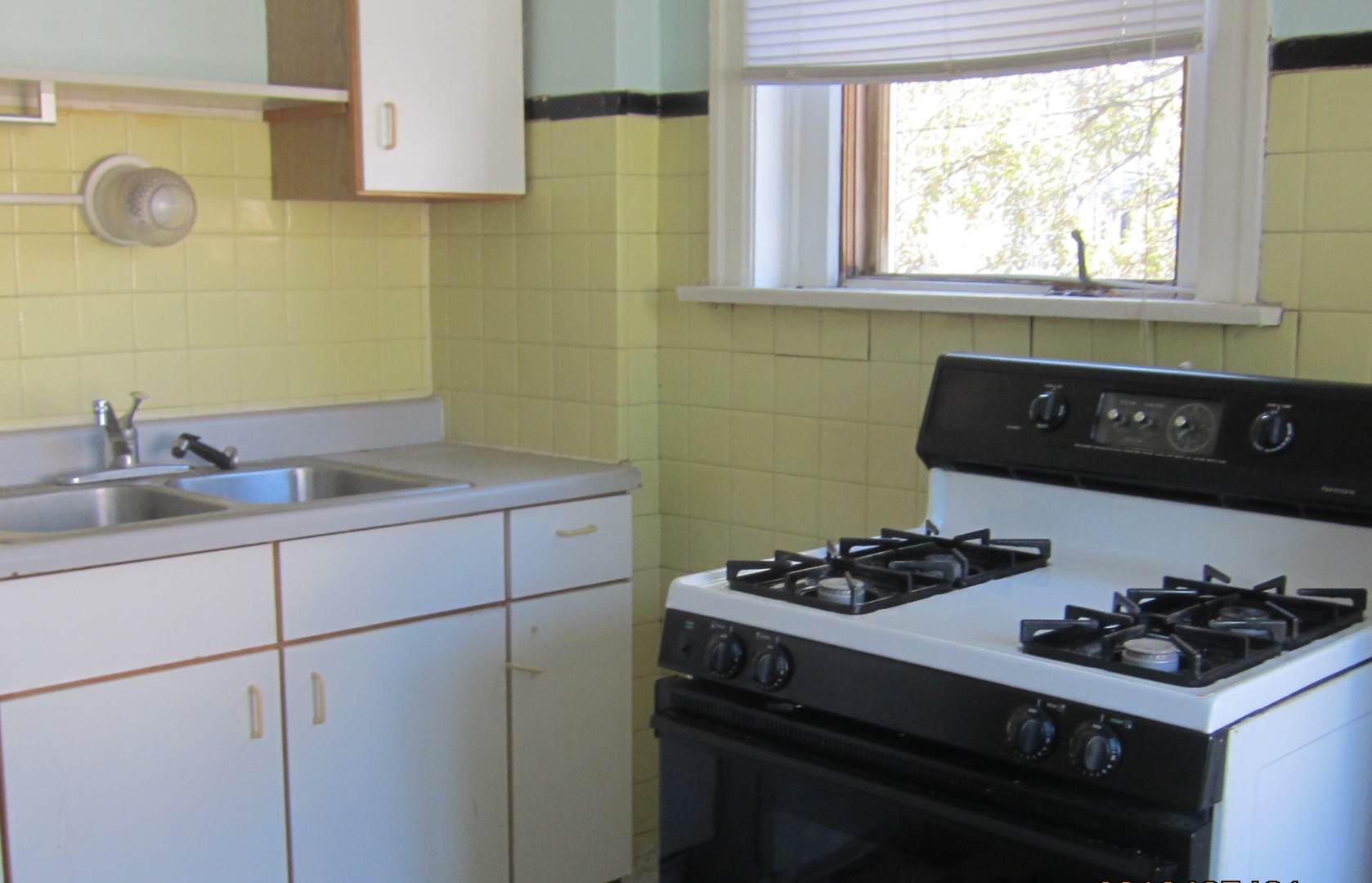 3534 West Wrightwood Avenue Chicago, IL 60647 - Photo 13 of 15 a kitchen with a sink cabinets and window