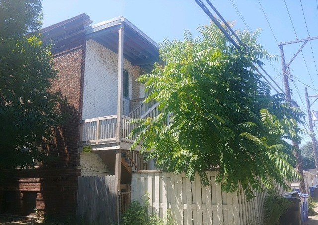 3534 West Wrightwood Avenue Chicago, IL 60647 - Photo 3 of 15 a view of backyard with potted plants and wooden fence