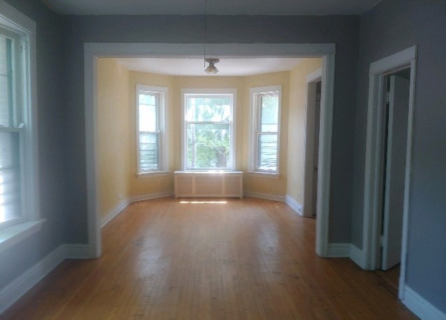 3534 West Wrightwood Avenue Chicago, IL 60647 - Photo 7 of 15 a view of an empty room with wooden floor and a window