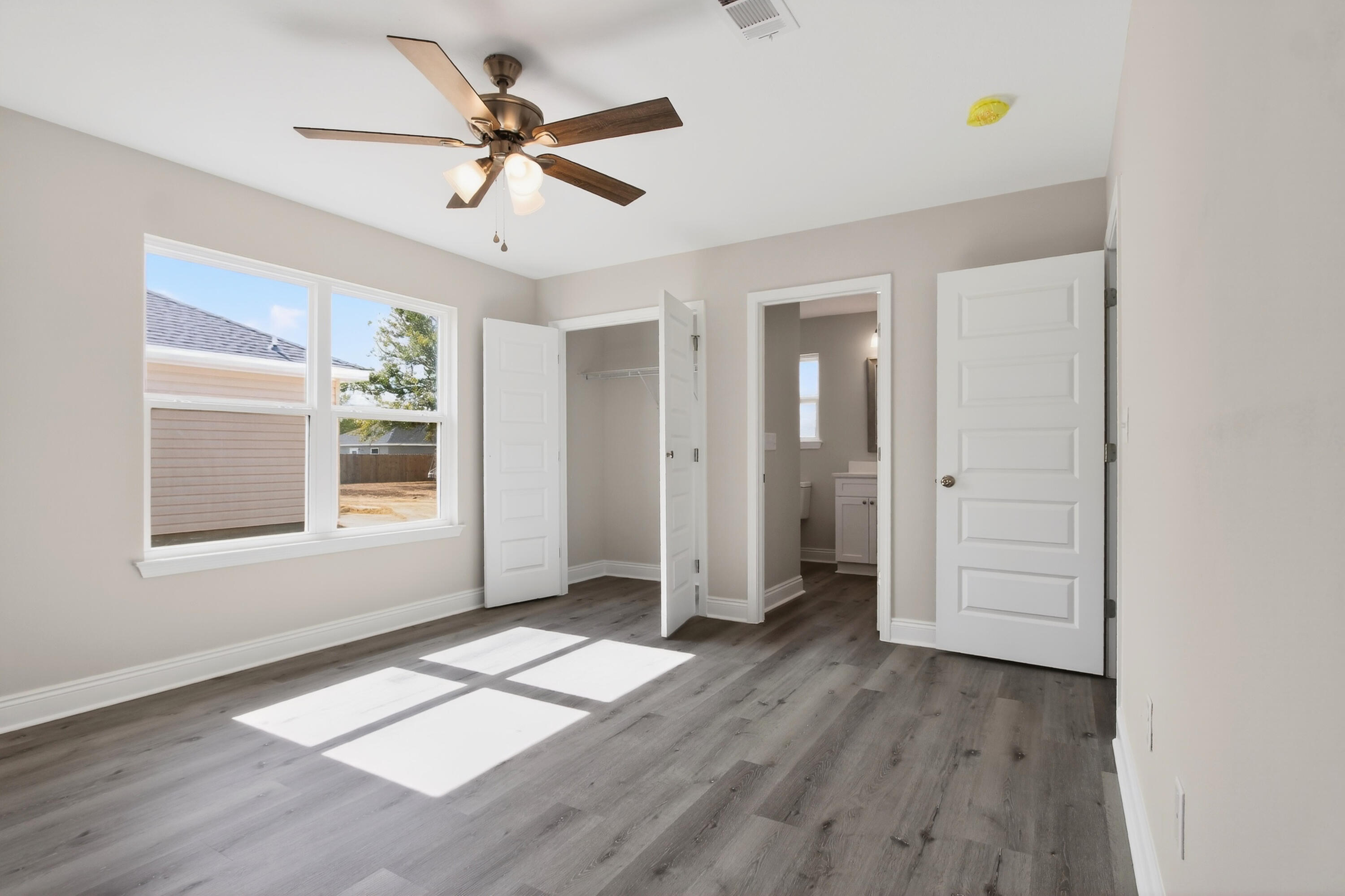 5358 Highview Drive Crestview, FL 32539 - Photo 19 of 31 wooden floor in an empty room with a window