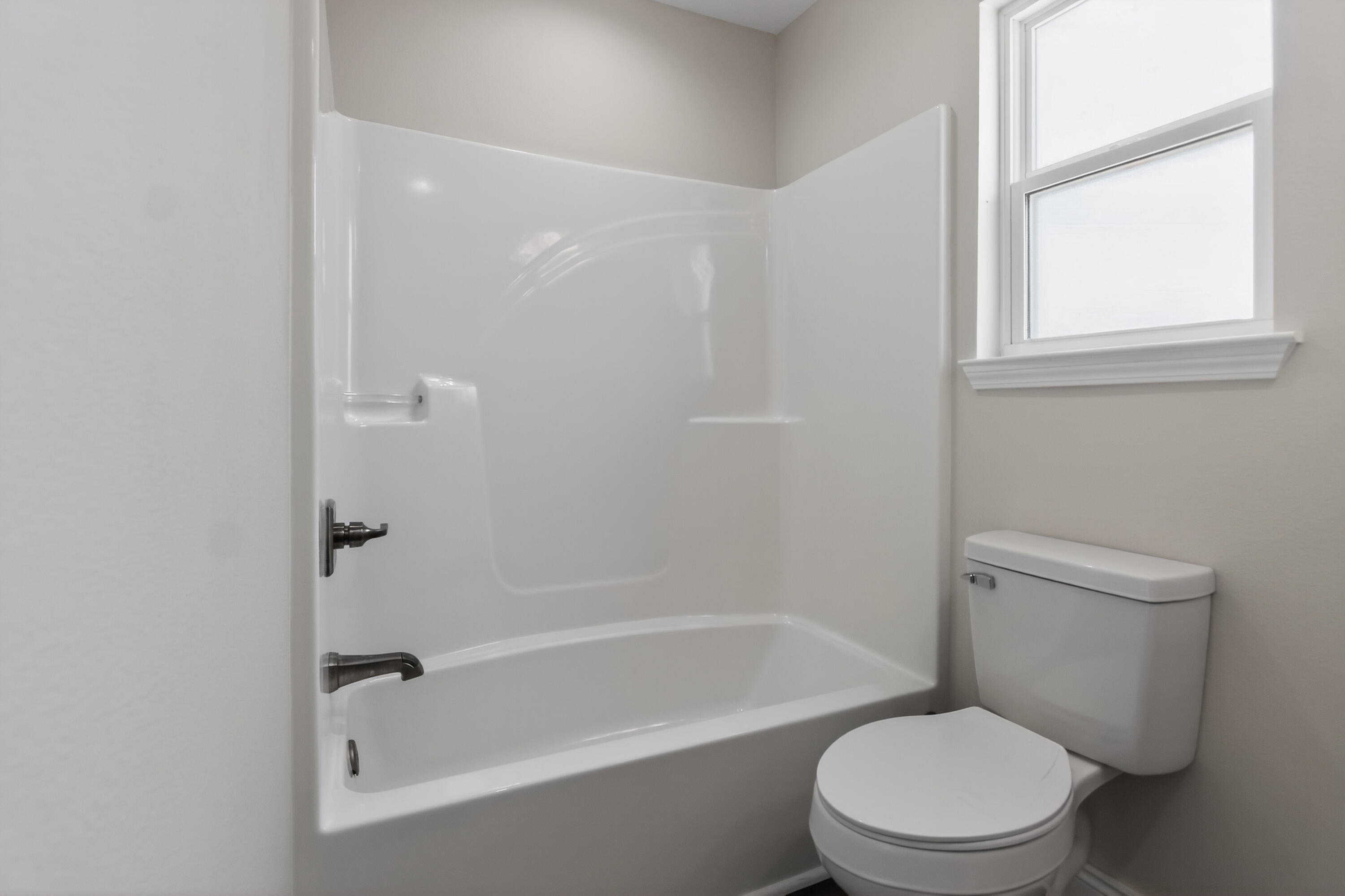 5358 Highview Drive Crestview, FL 32539 - Photo 21 of 31 a white toilet and tub next to a window