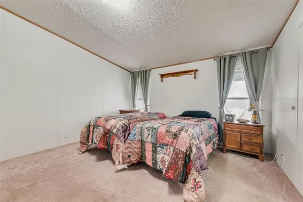 a bed sitting in a bedroom next to a window