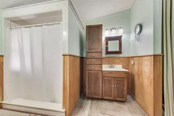 a bathroom with a sink a mirror and a shower
