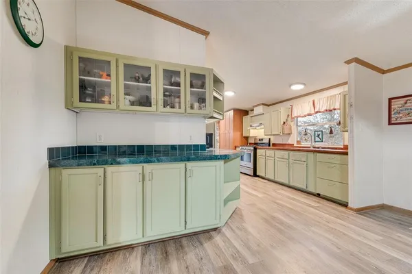 a kitchen with stainless steel appliances granite countertop a stove and a sink