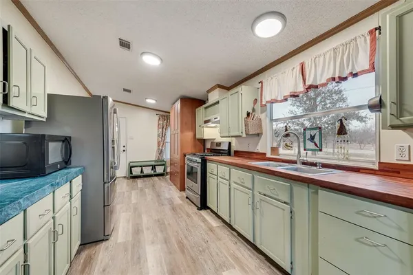 a kitchen with stainless steel appliances sink microwave and stove