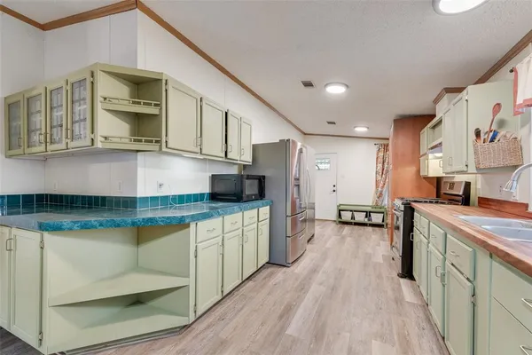 a kitchen with stainless steel appliances granite countertop a sink and cabinets