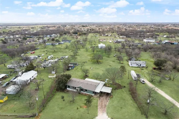 an aerial view of a house with a yard