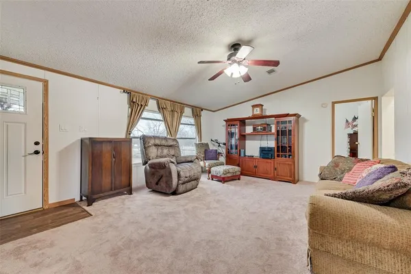 a living room with furniture gym equipment and a large window