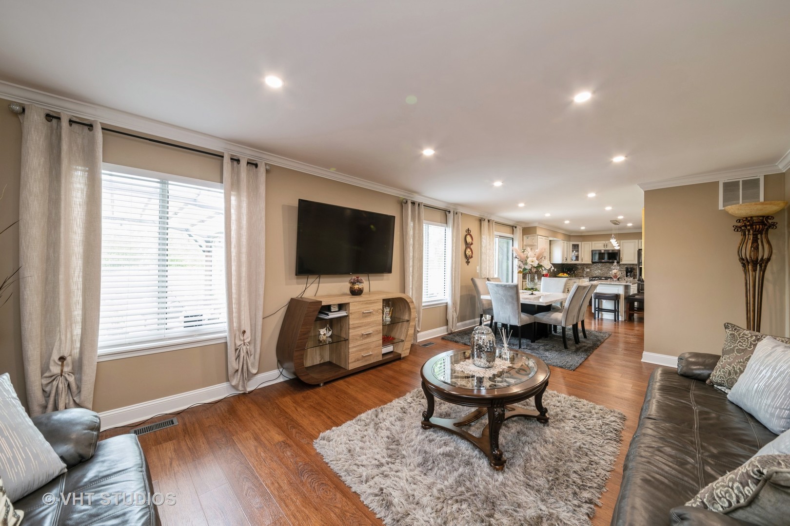 1026 Longford Road Bartlett, IL 60103 - Photo 12 of 24 a living room with furniture a flat screen tv and a large window