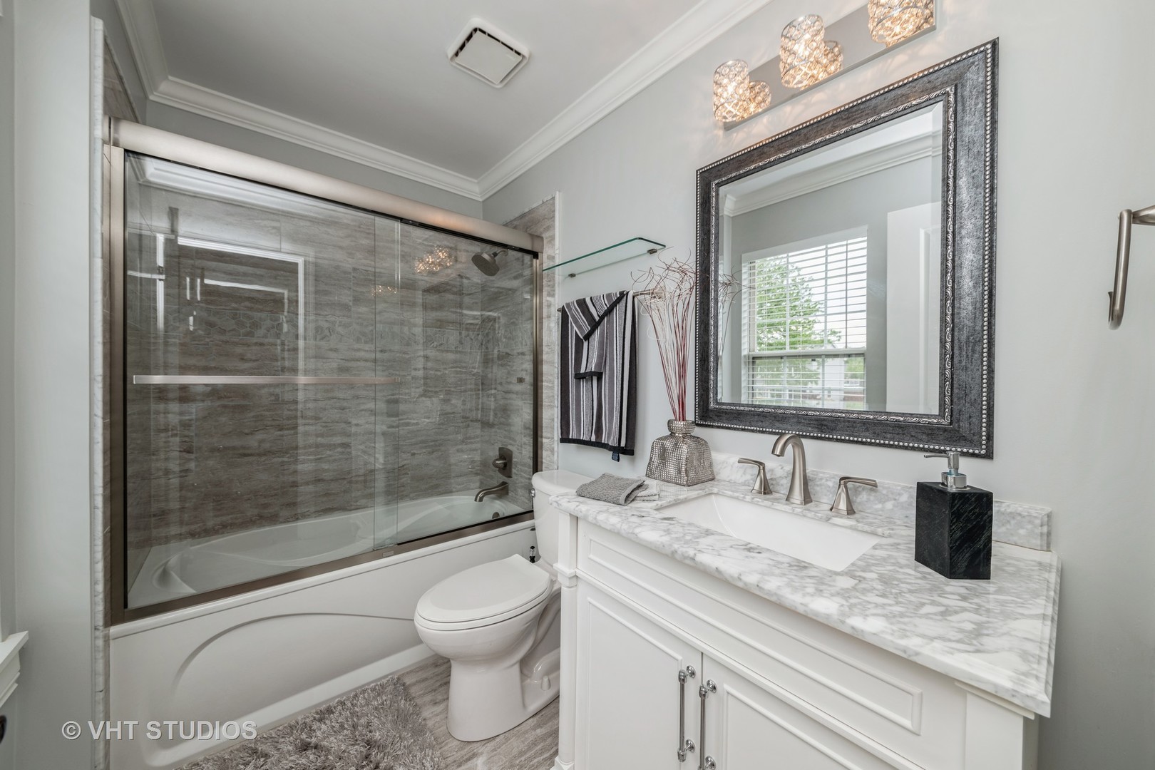 1026 Longford Road Bartlett, IL 60103 - Photo 17 of 24 a bathroom with a granite countertop sink a toilet a mirror and shower
